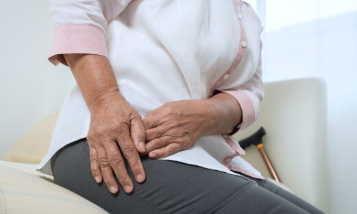 Elderly woman experiencing hip pain caused by bursitis.