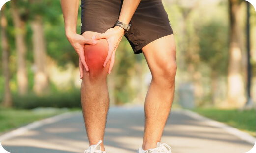 Man holding knee radiating pain.