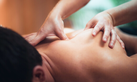 Man receiving remedial massage for muscle pain.