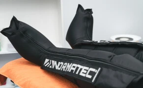 Patient relaxing while wearing NormaTec compression boots.