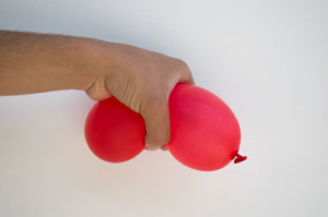 Balloon being squeezed in a hand